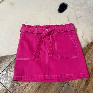 Blue Spice pink mini skirt with white stitching and a tie belt